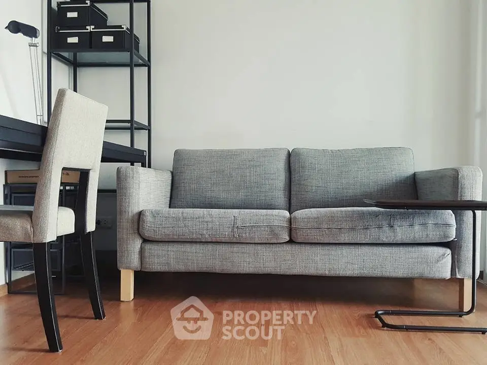 Modern living room with stylish gray sofa and sleek wooden flooring