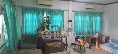 Cozy living room with air conditioning and teal curtains, ideal for relaxation.