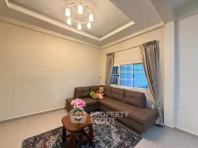 Cozy living room with modern lighting and plush sofa, perfect for relaxation.