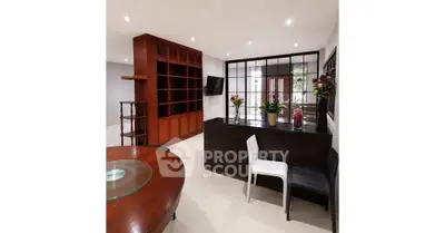 Spacious living room with modern decor and elegant wooden shelving