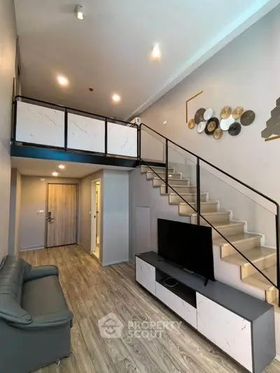 Modern loft-style living room with mezzanine, sleek staircase, and stylish decor.