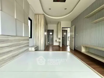 Spacious modern room with elegant wood paneling and built-in shelves, perfect for stylish living.