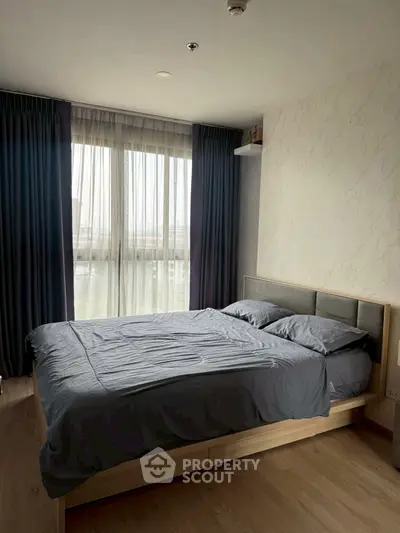 Modern bedroom with large window and stylish decor