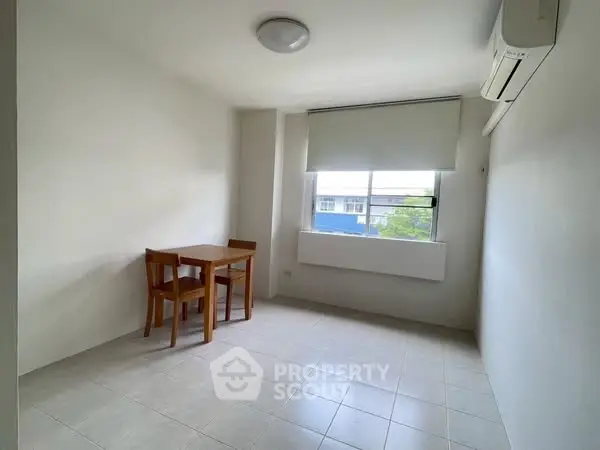 Minimalist room with table, chairs, and air conditioning, perfect for cozy living.