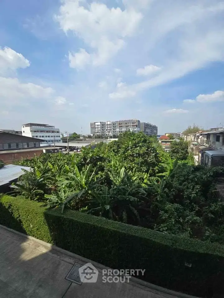 Stunning urban view with lush greenery and modern buildings under a clear blue sky.