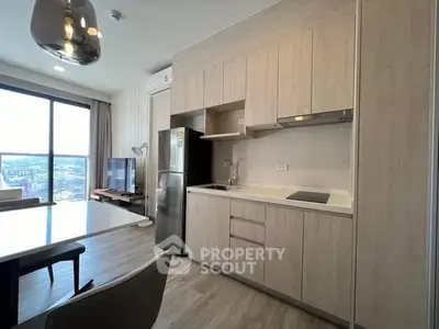 Modern kitchen with sleek cabinetry and open layout in bright apartment
