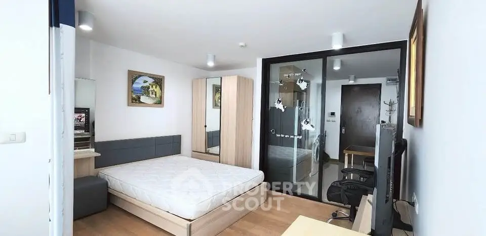 Modern bedroom with stylish decor and large mirror in a contemporary apartment.