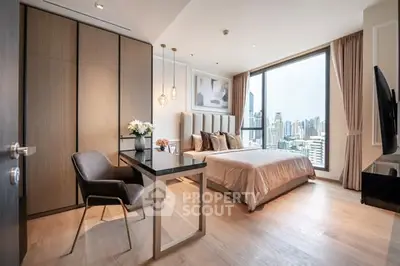 Luxurious bedroom with city view, modern furnishings, and elegant decor.