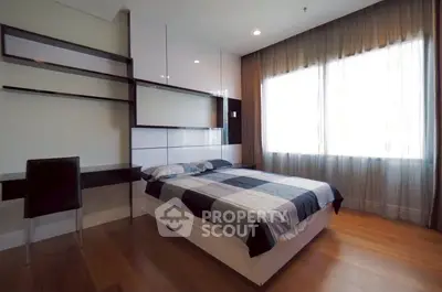 Modern bedroom with stylish decor and large window for natural light