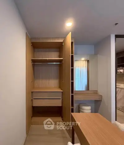 Modern apartment interior with open wooden wardrobe and vanity area