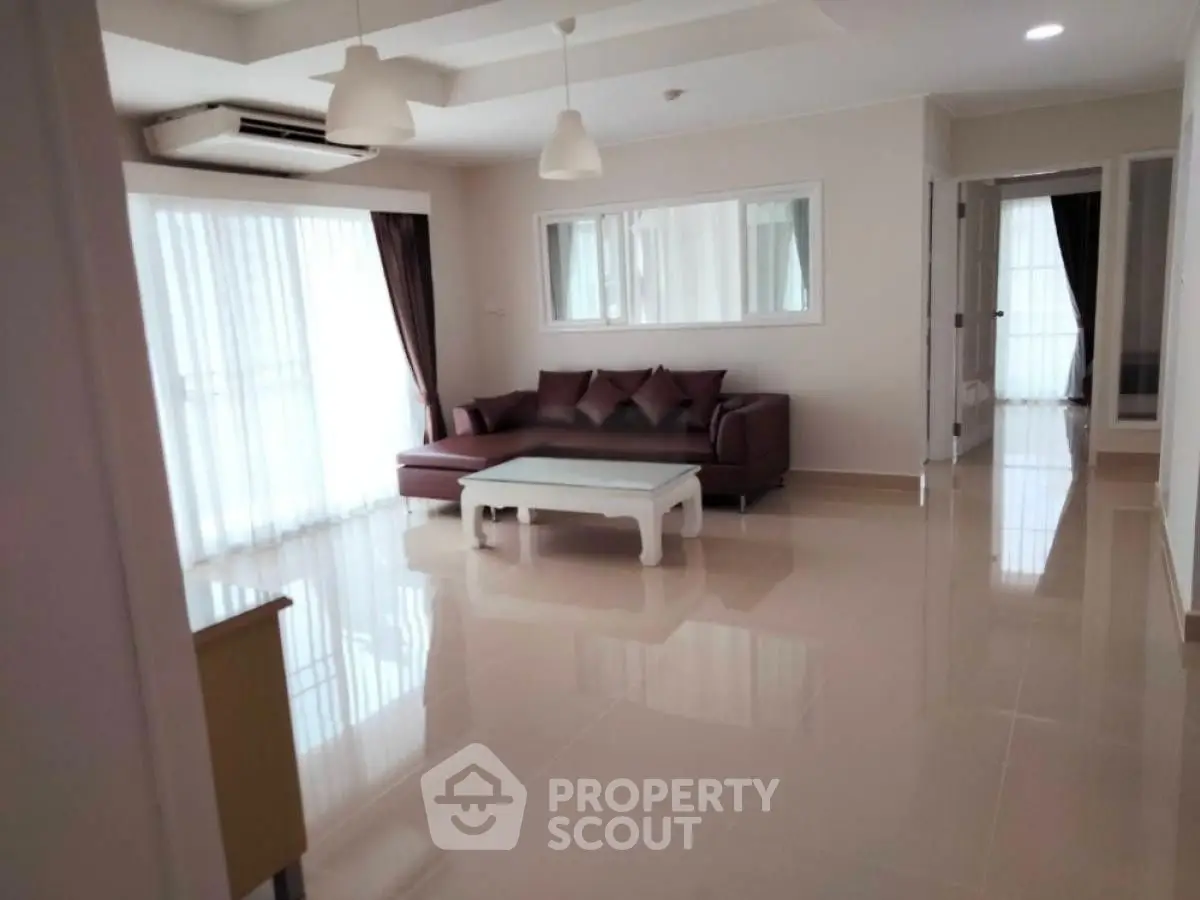 Spacious living room with modern furniture and large windows for natural light.