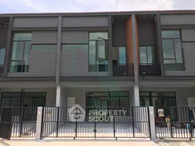 Modern townhouse exterior with sleek design and large windows, perfect for contemporary living.