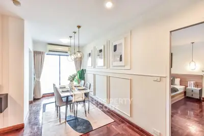 Elegant dining area with modern decor and adjacent bedroom in a stylish apartment.
