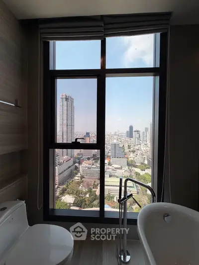 Luxurious bathroom with stunning city view from high-rise window