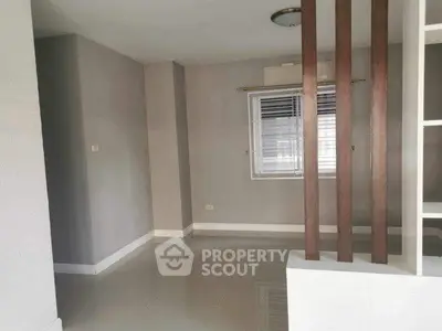 Spacious empty room with modern design and large window, ideal for customization.