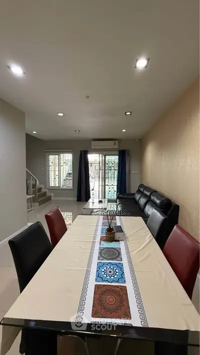 Spacious living room with elegant dining area and modern decor in a stylish home.
