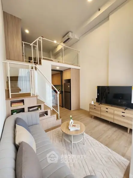 Modern loft apartment with stylish living room and mezzanine, featuring sleek furniture and open layout.