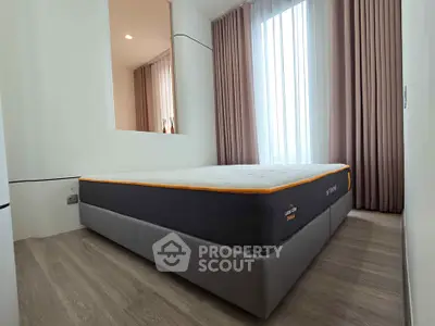 Modern bedroom with stylish decor and large window for natural light