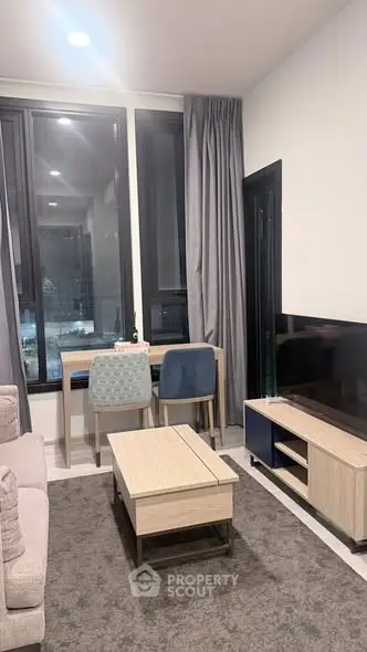 Modern living room with stylish furniture and large windows offering natural light.