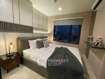 Modern bedroom with city view, stylish decor, and cozy ambiance.