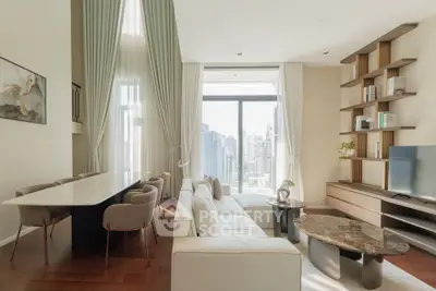 Luxurious living room with high ceilings and city view, featuring elegant furniture and modern decor.