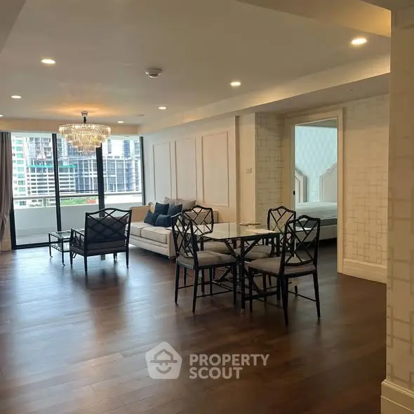 Spacious modern living room with elegant decor and city view balcony.