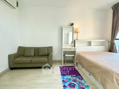 Modern bedroom with cozy sofa and stylish decor