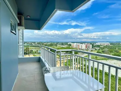 Spacious balcony with stunning panoramic view of cityscape and lush greenery.