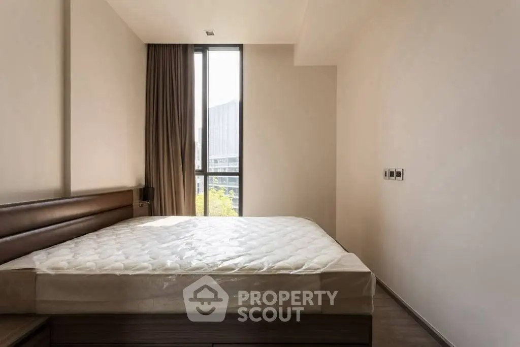 Spacious bedroom with large window and modern design