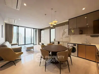 Modern open-plan living room with city view, featuring sleek kitchen and stylish dining area.