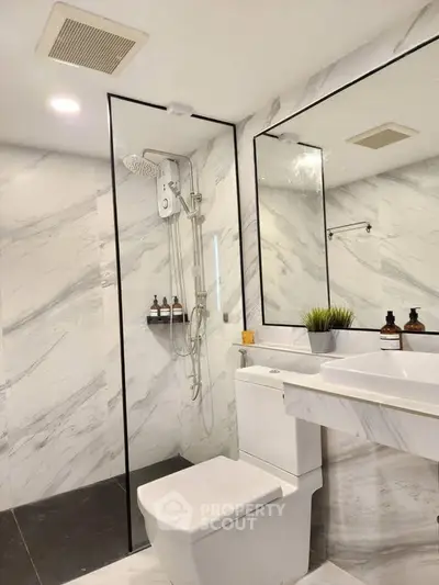 Luxurious modern bathroom with marble walls and sleek fixtures