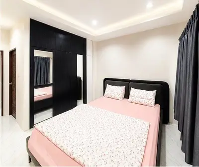 Modern bedroom with sleek black wardrobe and cozy pink bedding