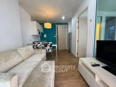 Modern living room with stylish decor and open kitchen layout in a cozy apartment.