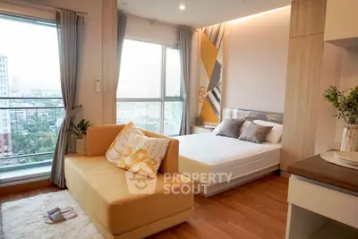 Modern bedroom with large windows and stylish decor in a high-rise apartment.