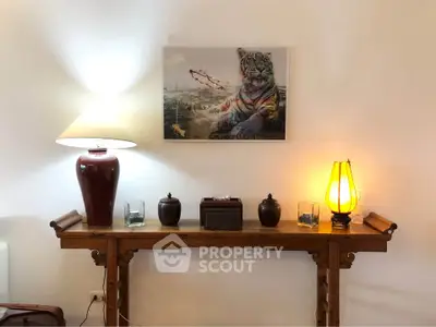 Elegant interior with decorative console table and ambient lighting, featuring unique tiger artwork.