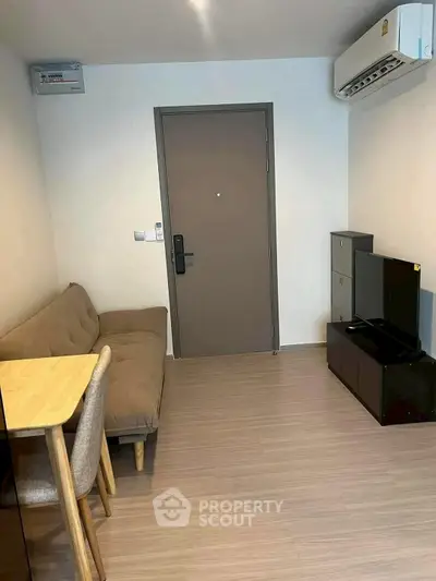 Cozy living room with modern furniture and air conditioning in a compact apartment.