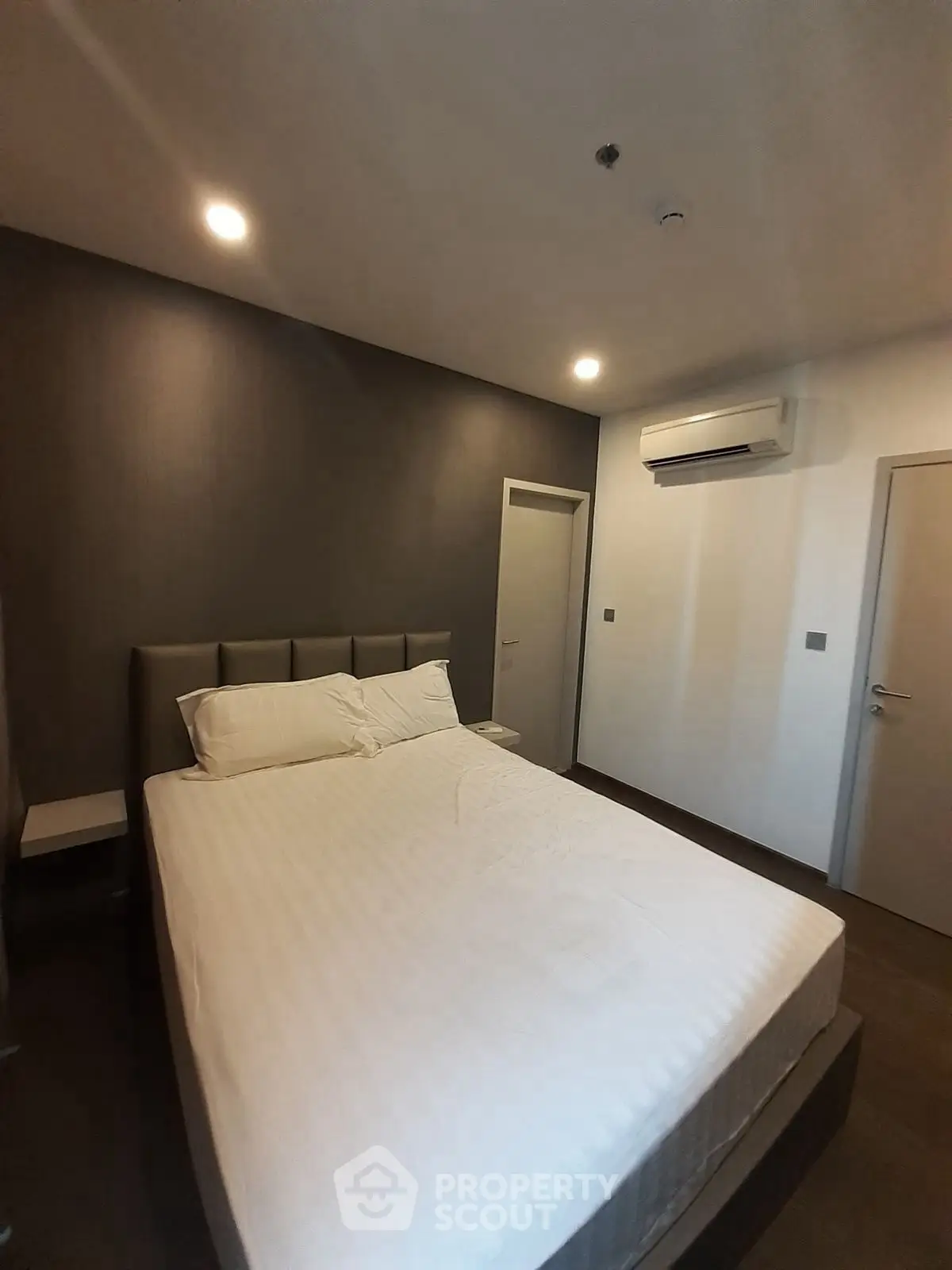 Modern bedroom with minimalist design and air conditioning unit
