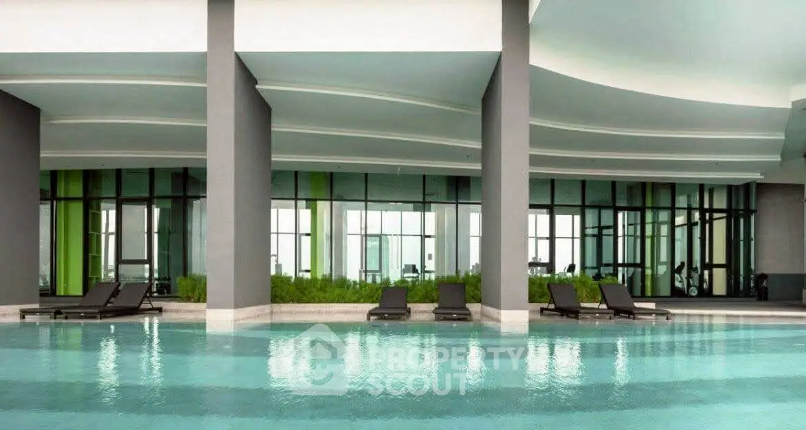 Luxurious modern pool area with sleek design and comfortable lounge chairs, perfect for relaxation.
