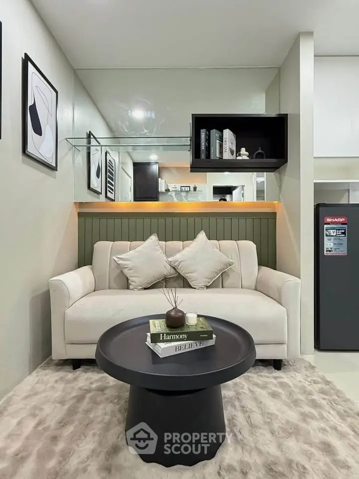 Modern living room with cozy sofa, stylish decor, and sleek furniture in a contemporary apartment.