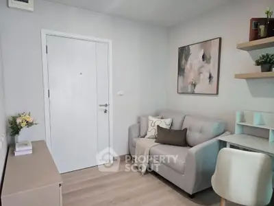 Cozy living room with modern decor, featuring a comfortable sofa, stylish artwork, and elegant shelving.