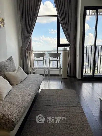 Modern living room with stunning city view and cozy seating area.