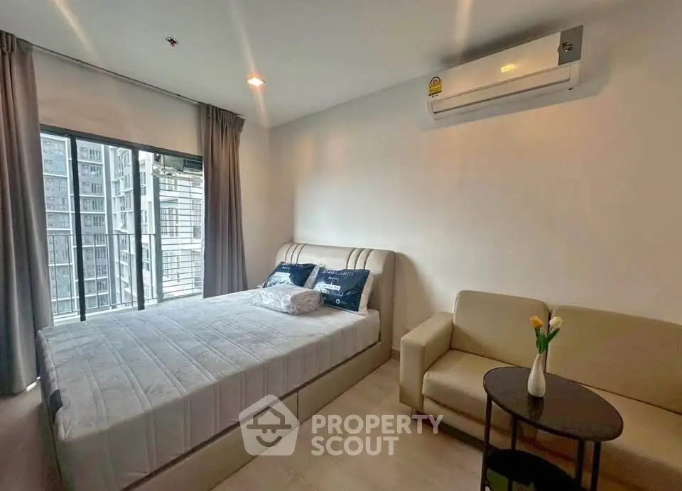 Modern bedroom with large window and air conditioning in a high-rise apartment.