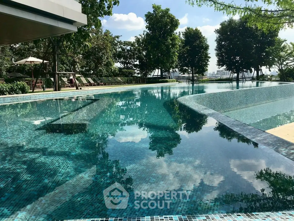 Luxurious infinity pool with serene surroundings and lush greenery, perfect for relaxation.