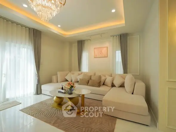 Luxurious living room with elegant chandelier and plush sectional sofa