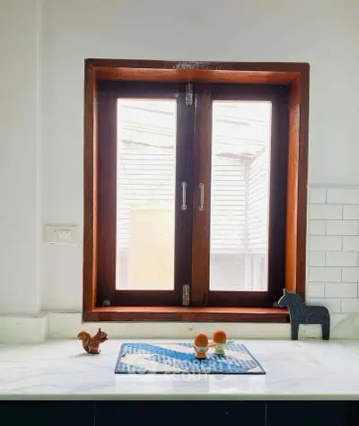 Charming kitchen window with wooden frame and decorative accents