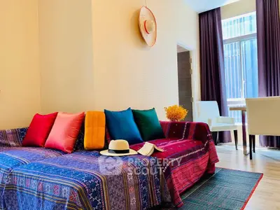 Vibrant living room with colorful cushions and natural light, perfect for relaxation and entertaining.