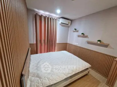 Cozy bedroom with modern decor and air conditioning in a stylish apartment.