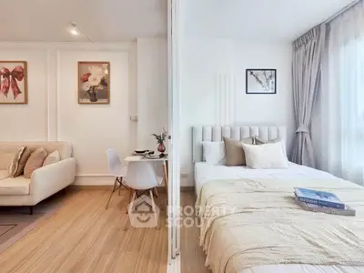Modern studio apartment with cozy living area and stylish bedroom, featuring elegant decor and natural light.