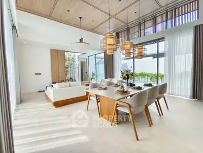 Luxurious open-plan living and dining area with modern decor and abundant natural light.