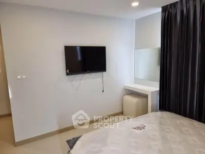 Modern bedroom with wall-mounted TV and sleek decor